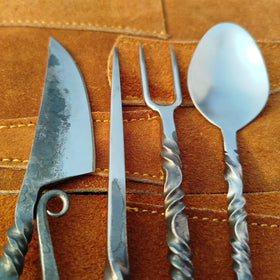 Generic medieval dining scene with cutlery, evokes authentic Norse-inspired meals.