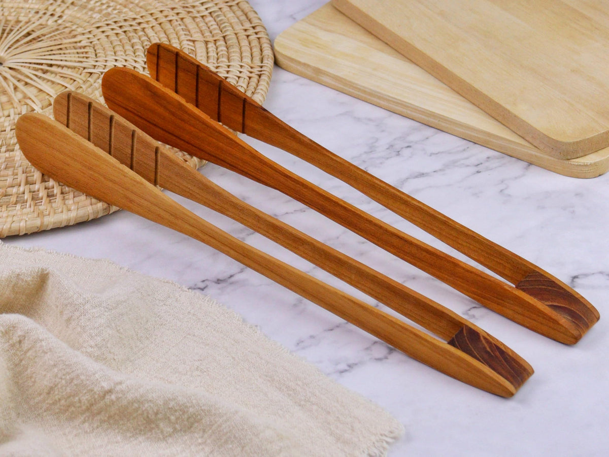 Generic Teak Wood Toast Tongs picking up toast with a secure grip.