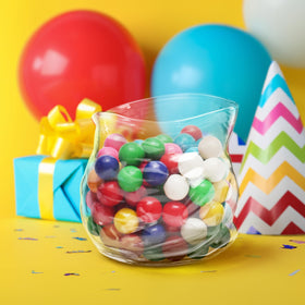 Genuine Fred UNZIPPED bowl filled with snacks on a coffee table for social moments.