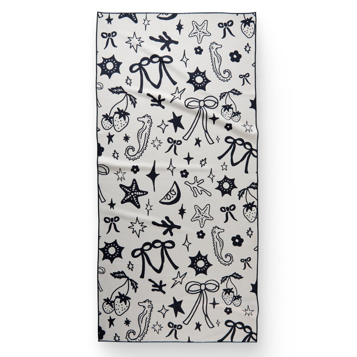 GEOMETRY Micro-Loop Beach Towel on sunlit sand demonstrates quick-dry performance.