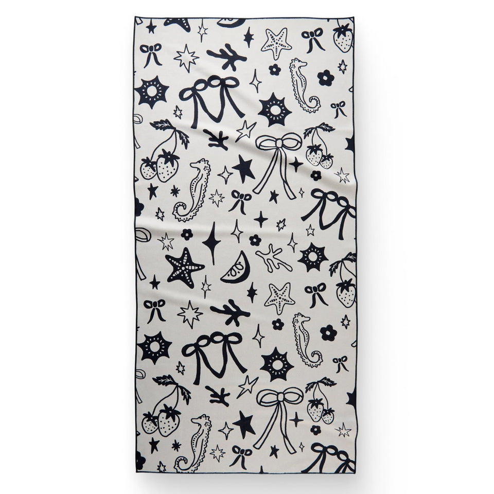 GEOMETRY Micro-Loop Beach Towel on sunlit sand demonstrates quick-dry performance.