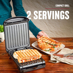 George Foreman Compact tilt-fat-drain demonstrates fat-removing cooking for cleaner results.