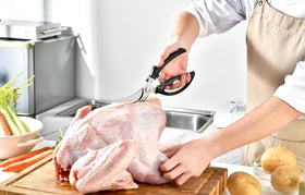 Gerior heavy duty poultry shears in use for cutting raw chicken.