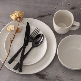 Gibson Home Oslo round coupe design enhances modern table setting.