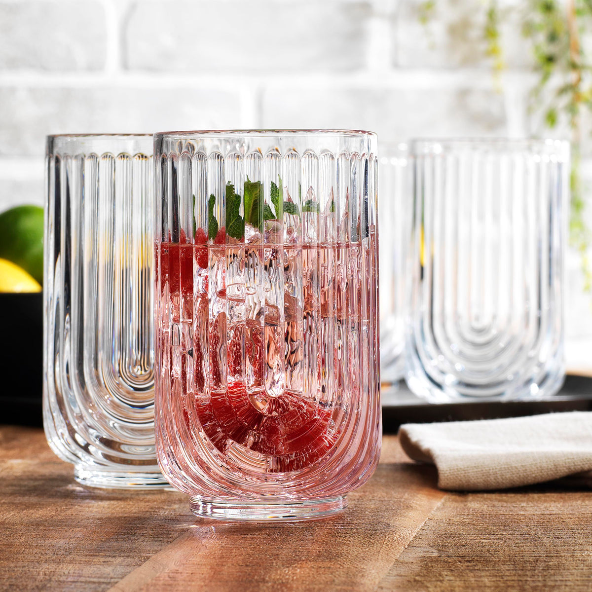 Glaver's embossed arch pattern highball glass adding vintage charm to any table.