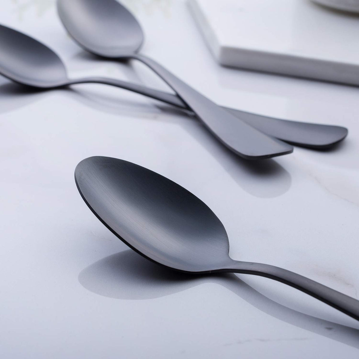 GoGeiLi matte black spoons on a modern table setting for stylish dining