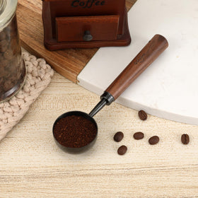 Gonzone walnut-handle spoon offering a comfortable grip during measurement.