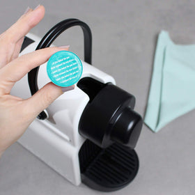 Gourmesso cleaning pod with clear usage instructions—do not drink.