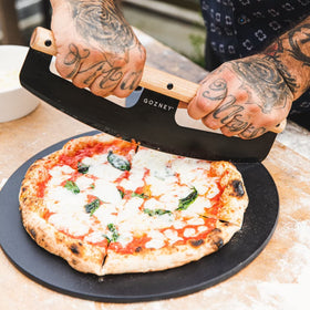 Gozney pizza rocker wooden handle demonstrates ergonomic grip for comfortable cutting