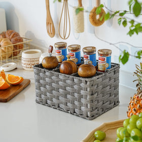 GRANNY SAYS wicker utensil caddy on kitchen table showing organized compartments.