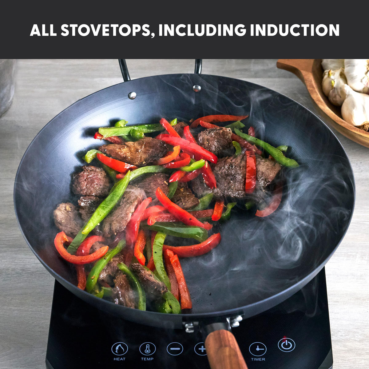 GreenPan Kyoto wok on induction stove showing flat-base compatibility.