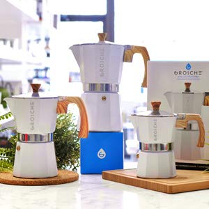 GROSCHE Milano Moka Pot pouring into cup with inviting aroma.