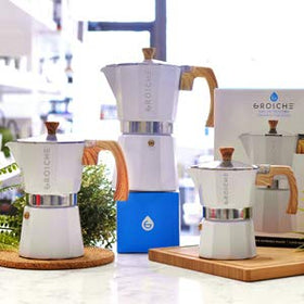 GROSCHE Milano Moka Pot pouring into cup with inviting aroma.