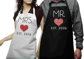 Mr. Est. 2026 and Mrs. Est. 2026 detailing on GSM Brands aprons, sentimental flair