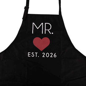 Matching design GSM Brands Mr. & Mrs. 2026 aprons emphasize togetherness in the kitchen