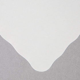 Guffman paper placemat's scalloped edge adds elegance to event decor.