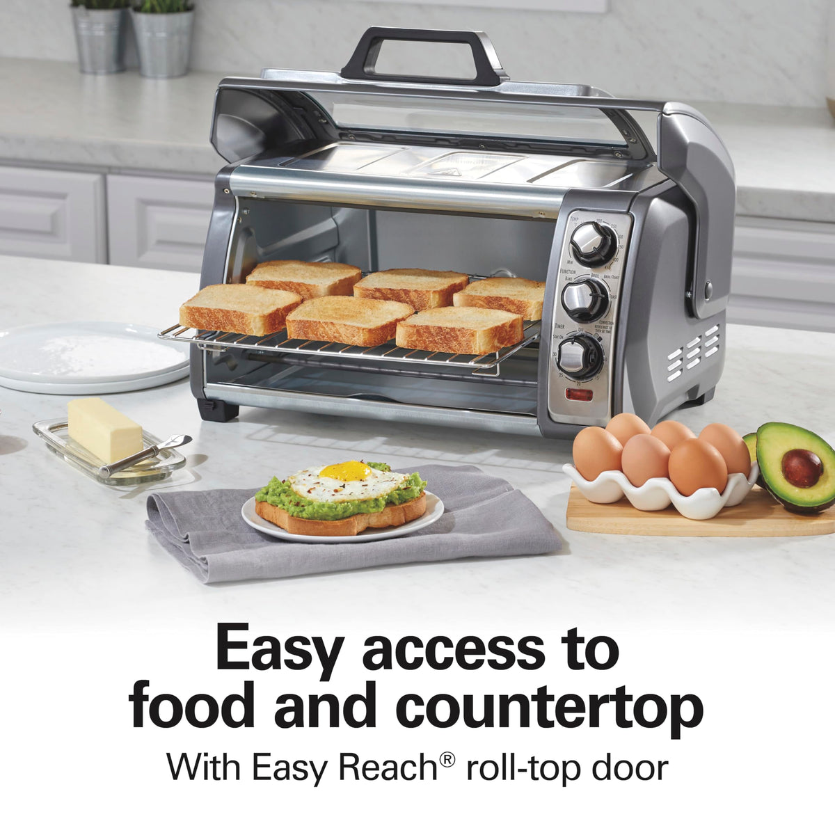Hamilton Beach Easy Reach toaster oven roll-top door rolled up, freeing counter space.