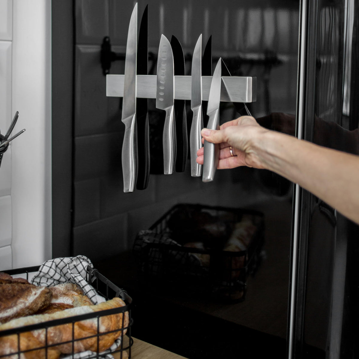 Closeup of Hamletoff double-sided magnet securing knives securely.