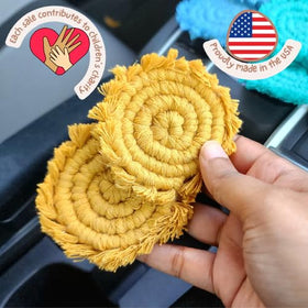Handmade By Uruba boho macrame coaster closeup showing intricate knots and texture.