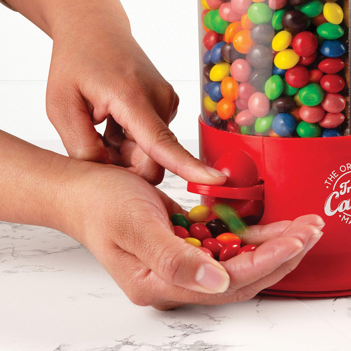 Handy Gourmet red candy dispenser rotates 360 degrees for easy selection.