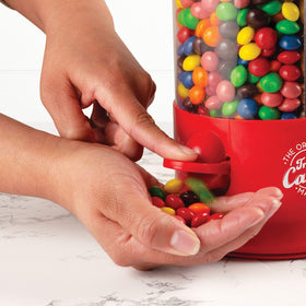 Handy Gourmet red candy dispenser rotates 360 degrees for easy selection.