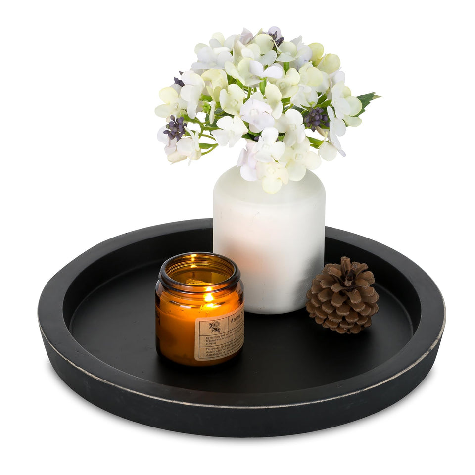 Hanobe round black tray showcasing a minimalist candle holder for chic coffee-table styling