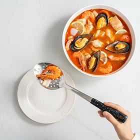 HAPPY KIT solid serving spoon ideal for scooping sauces and grains.