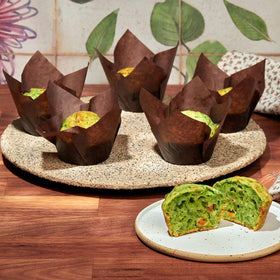 HARFINGTON baked cupcakes in green tulip liners on a tray