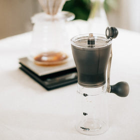 HARIO Ceramic Coffee Mill Original Black secure handleless storage feature.
