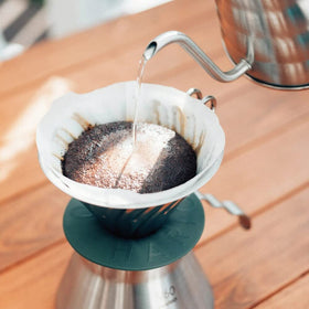 Hario Outdoor V60 metal dripper in a pour-over setup, ideal for quick, clean extractions.