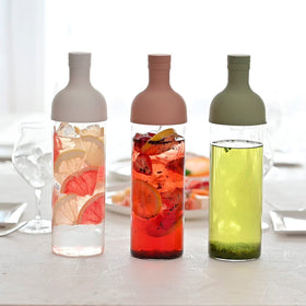 HARIO smoky-green bottle in use for tea and wine-inspired drinks