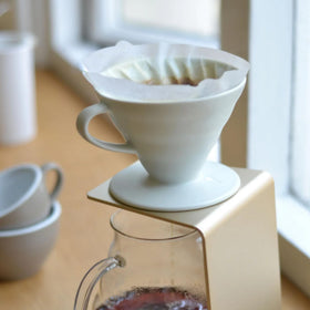 Hario V60 ceramic coffee dripper White, with filter, simple setup for quick pour-over.