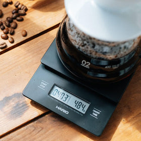 Hario V60 Drip Scale placed on a server to optimize counter space