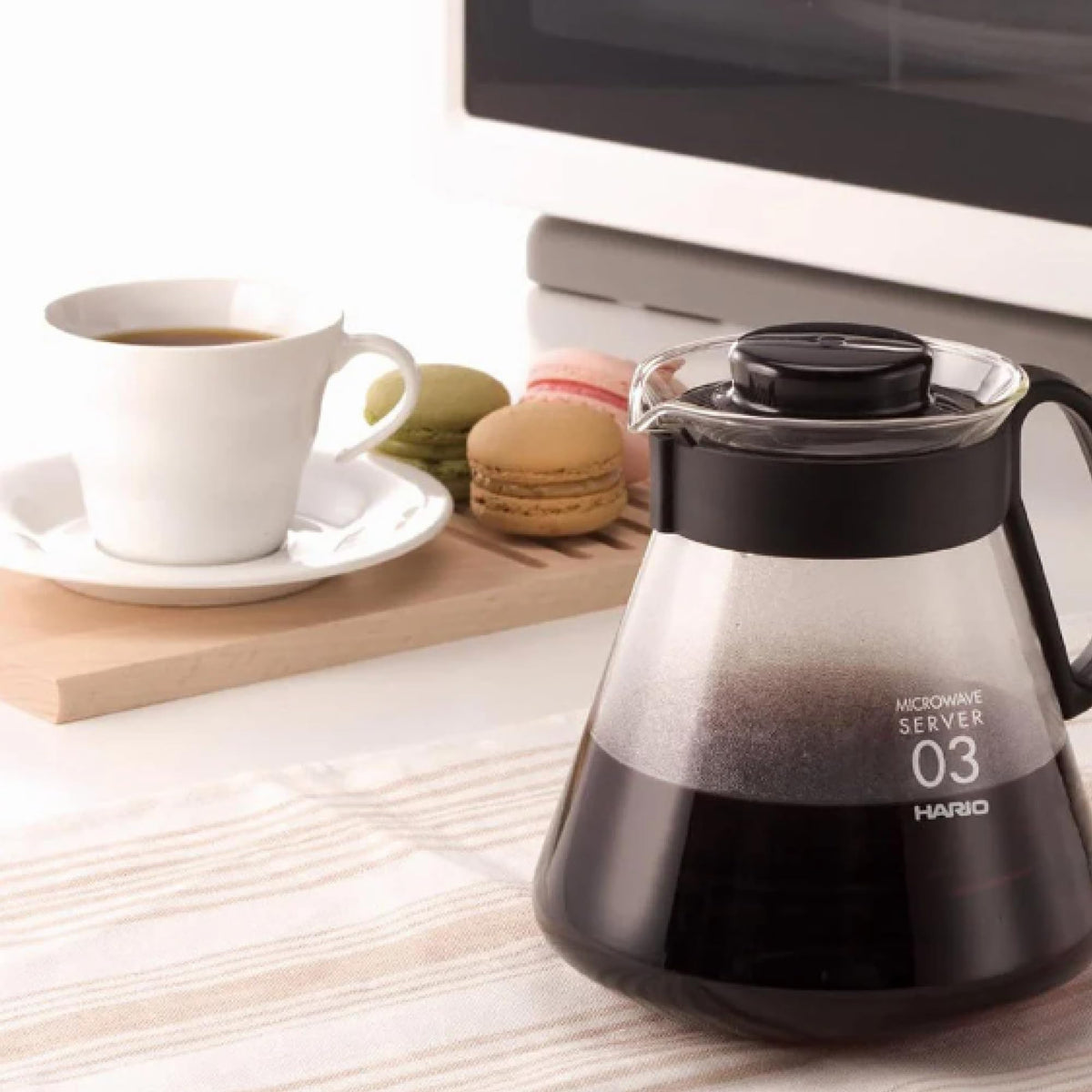 Hario V60 glass range coffee server on kitchen counter, easy to clean after use.