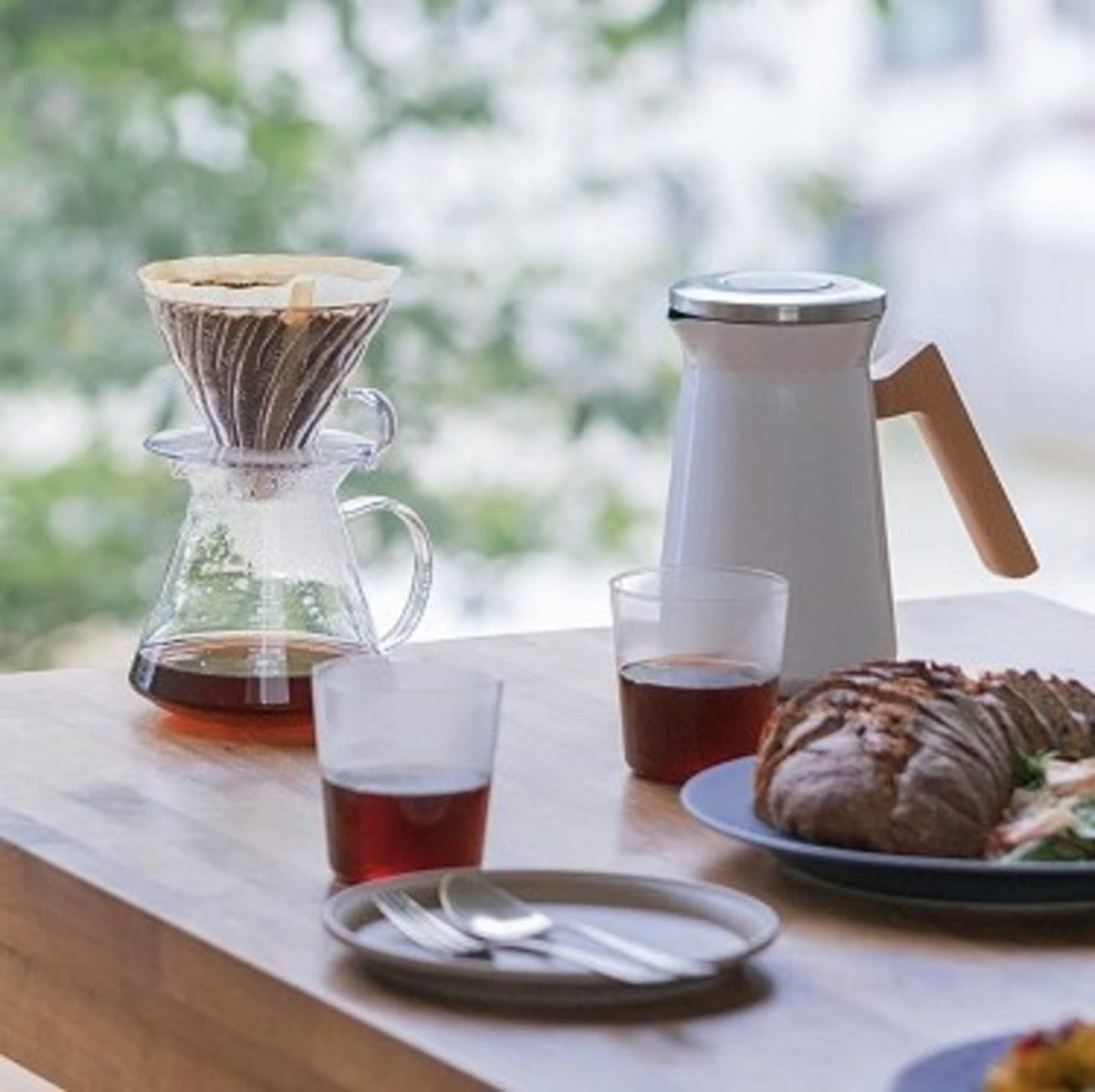 Hario V60 pour-over action shows controlled water flow.