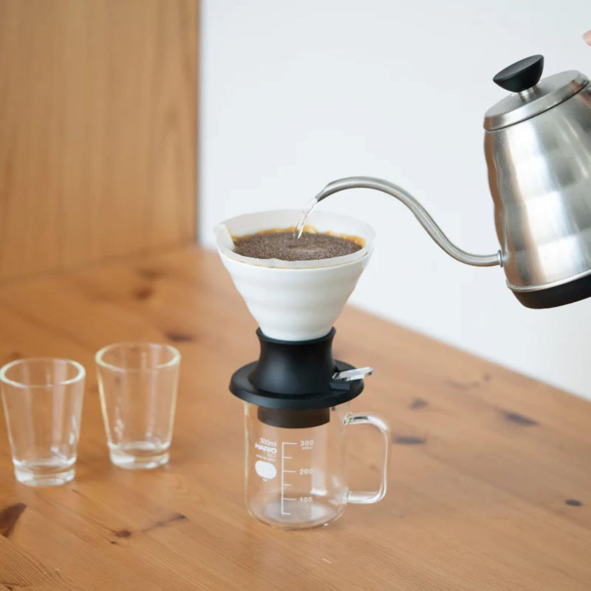Hario V60 Switch pour-over setup shows the white ceramic dripper ready for precise brewing.