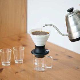 Hario V60 Switch pour-over setup shows the white ceramic dripper ready for precise brewing.