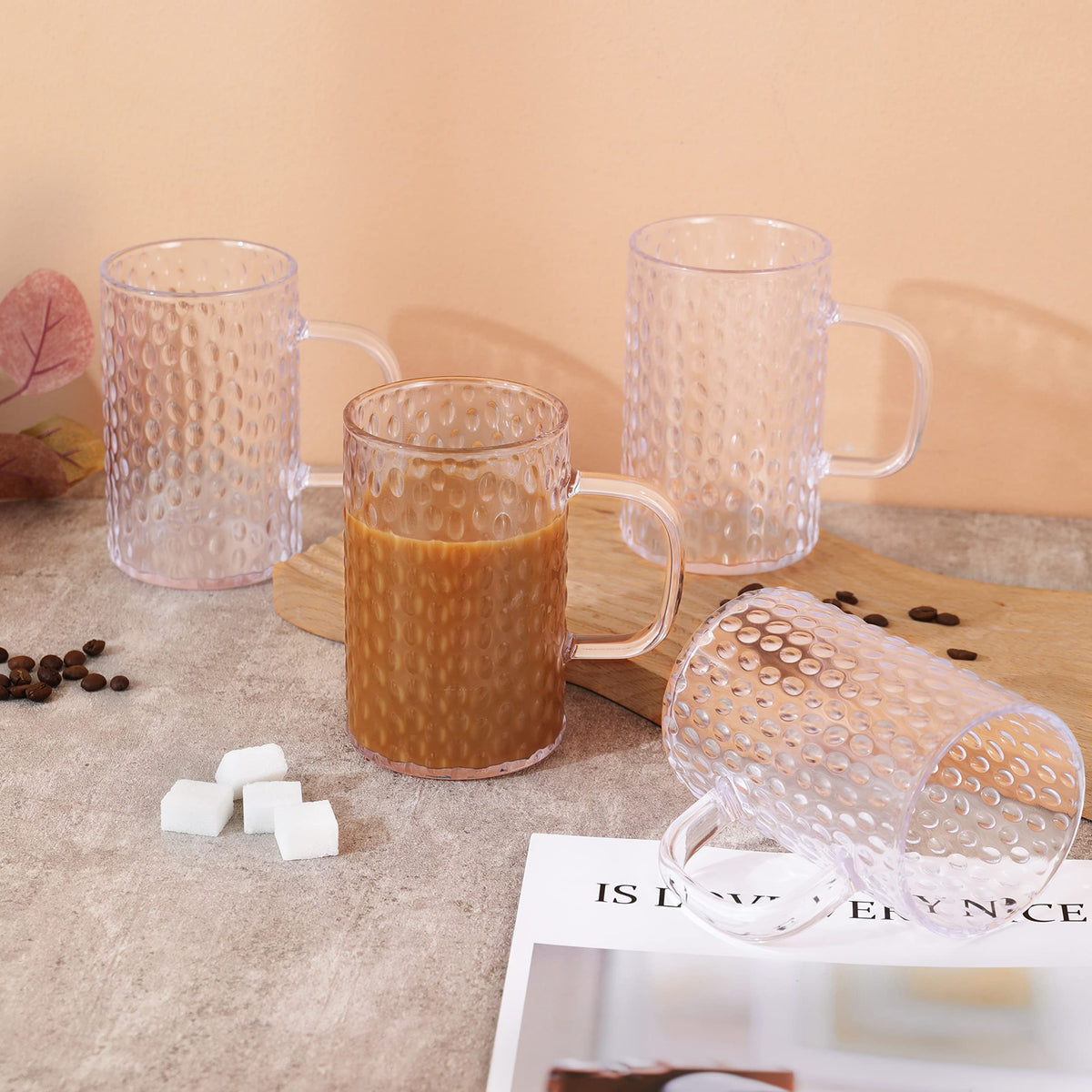 Unbreakable-looking clear mugs neatly stored in a kitchen cabinet.