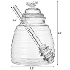 Long honey dipper resting beside Hedume jar for easy drizzle use.