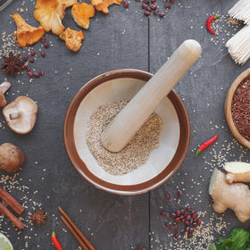Helen’s Asian Kitchen wooden Surikogi pestle fits the bowl for steady crushing.