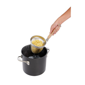 Helen's Asian Kitchen spider strainer hanging on pot for easy reach.