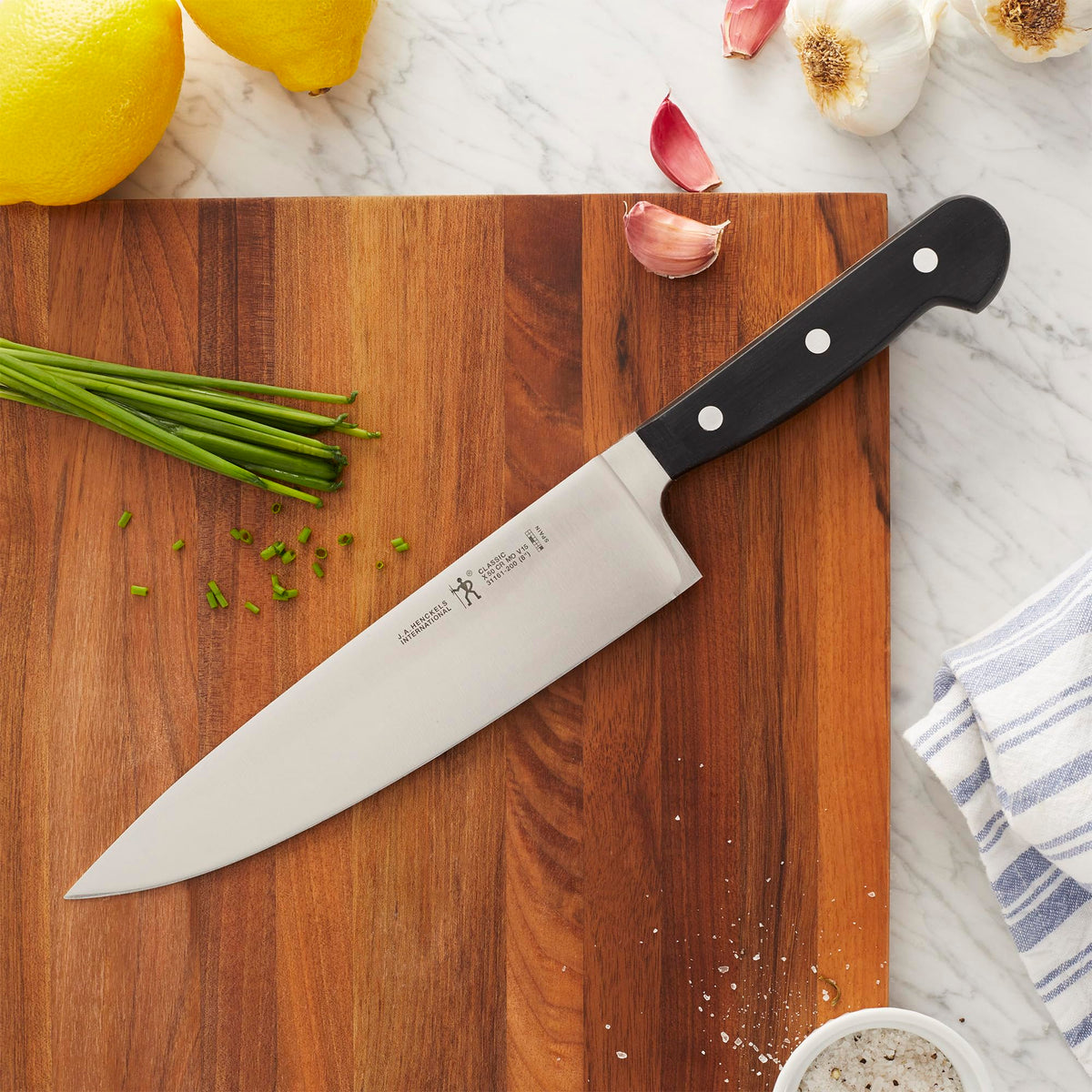 Henckels Classic 8-inch chef knife handle with balanced grip for daily use.