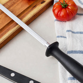 Henckels steel honing rod ready for daily knife maintenance on the counter.