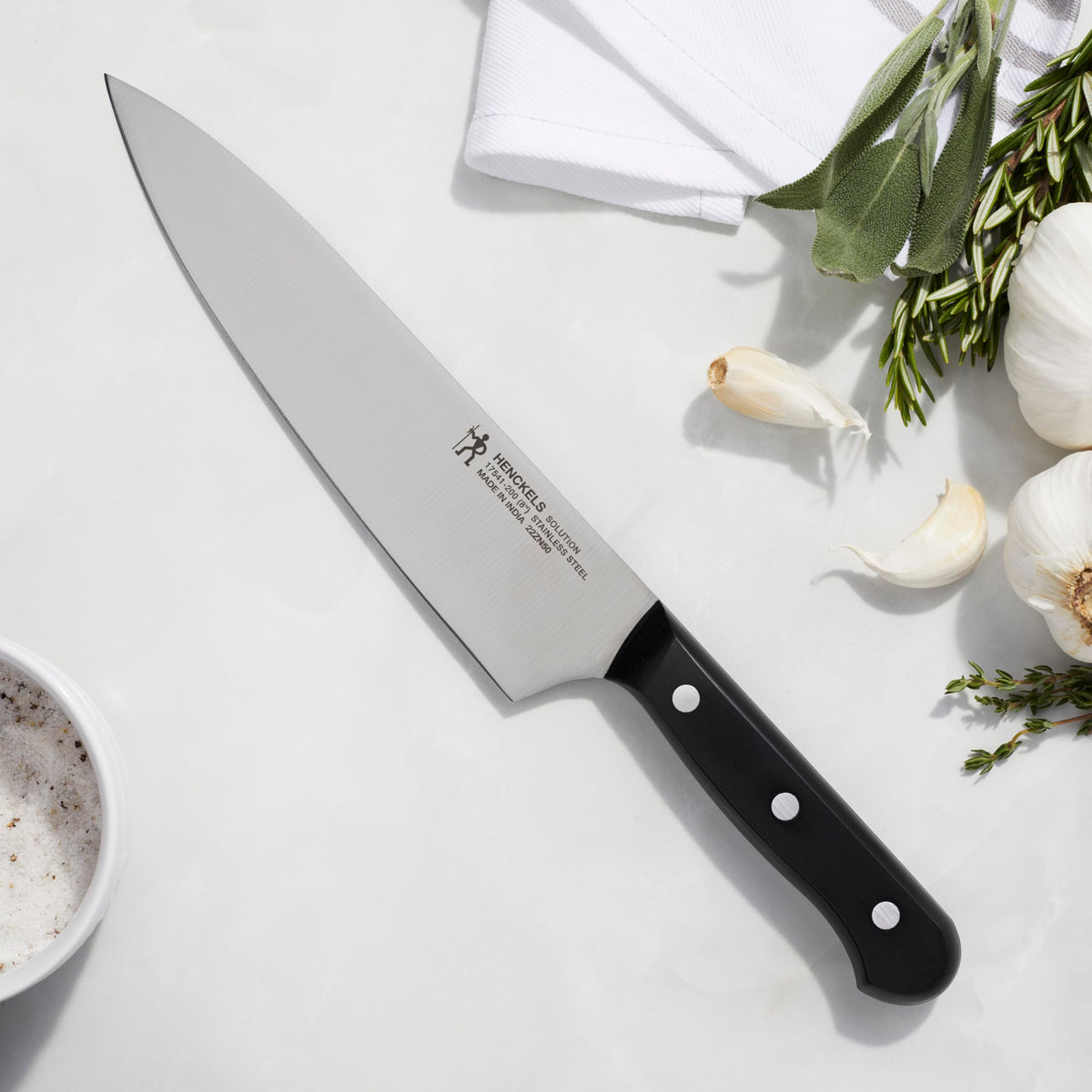 Henckels Solution Razor-Sharp 8-inch chef knife handle delivers durable grip and control.