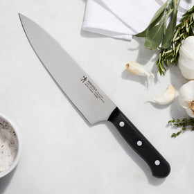 Henckels Solution Razor-Sharp 8-inch chef knife handle delivers durable grip and control.