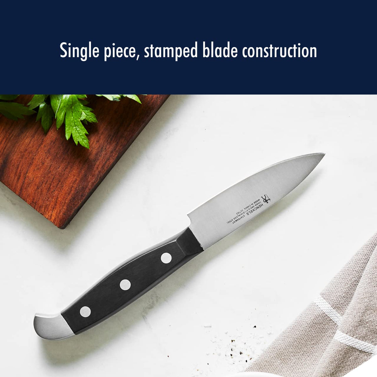 Henckels Statement 6-inch utility knife versatile for chopping and slicing.