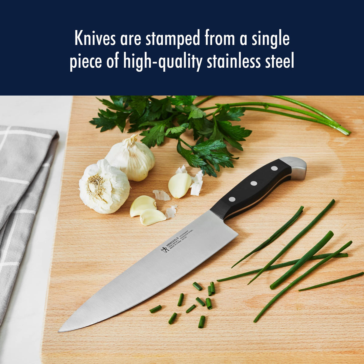 Henckels Statement 7-inch Santoku with grantons prevents sticking.