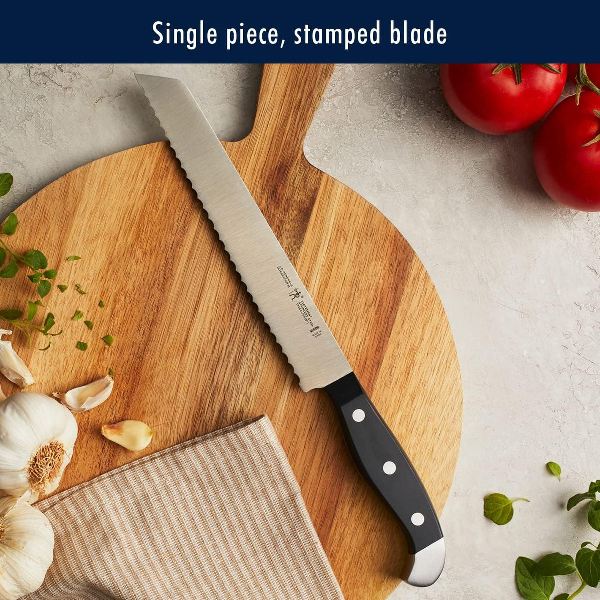 HENCKELS Statement 7-inch hollow-edge santoku reduces sticking for quick, clean mincing.