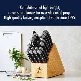 Henckels Statement 8-inch chef knife in action for precise chopping.