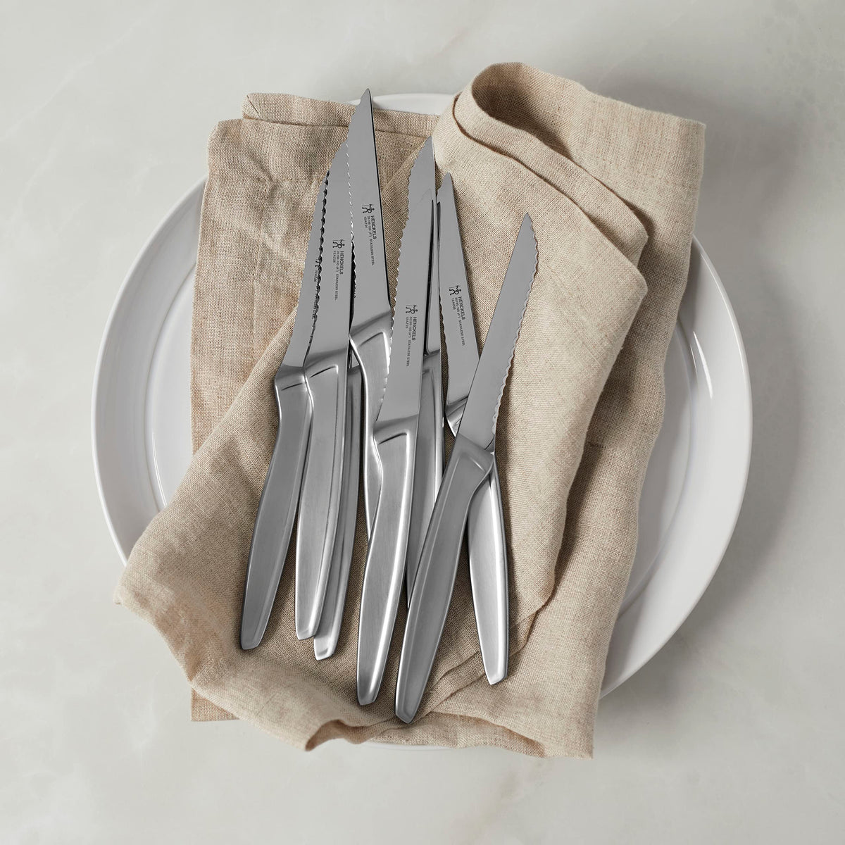 Henckels steak knife blade closeup showing durable single-piece construction and fine edge.